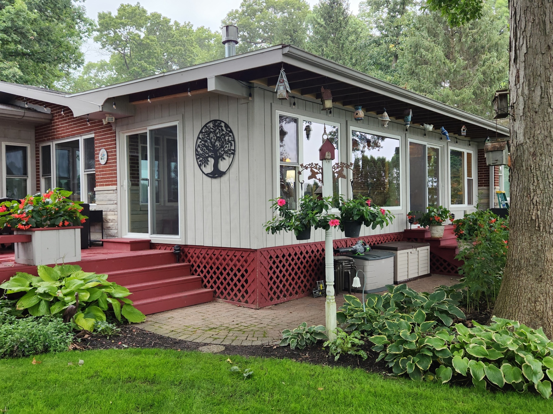 Lakefront sunroom exterior with new windows and slider system